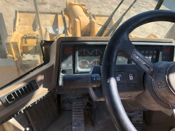 Steering wheel and dashboard of a 1996 Cat 950F II wheel loader.